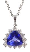 18ct white gold tanzanite and diamond cluster pendant, stamped 750 on platinum chain necklace,