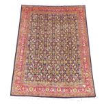 Persian Tabriz red ground rug, repeating Herati floral pattern on blue field, guarded boarder,
