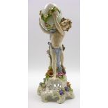 Late 19th Century German porcelain vase in the form of an egg supported by a cherub and on a floral