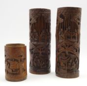 Pair of Chinese cylindrical bamboo vases carved with figures and landscapes H31cm and a smaller