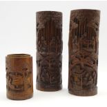 Pair of Chinese cylindrical bamboo vases carved with figures and landscapes H31cm and a smaller