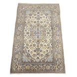 Persian Kashan ivory ground rug, central medallion surrounded by stylised floral motifs,