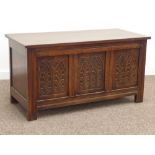 20th century medium oak chest, three panel front carved with arched foliage, hinged lid, W107cm,