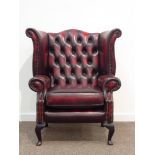 Georgian style wingback armchair upholstered in deeply buttoned ox-blood leather,