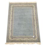 Persian blue ground rug, field decorated with all over repeating Boteh motifs,