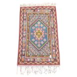 Turkish blue ground rug, field decorated with stylised motifs,
