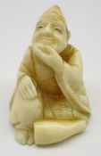 Late 19th Century Japanese carved ivory Netsuke in the form of a seated figure,