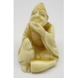 Late 19th Century Japanese carved ivory Netsuke in the form of a seated figure,