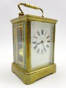 20th century brass and bevel glazed carriage clock, white Roman dial indistinctly signed,