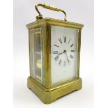 20th century brass and bevel glazed carriage clock, white Roman dial indistinctly signed,