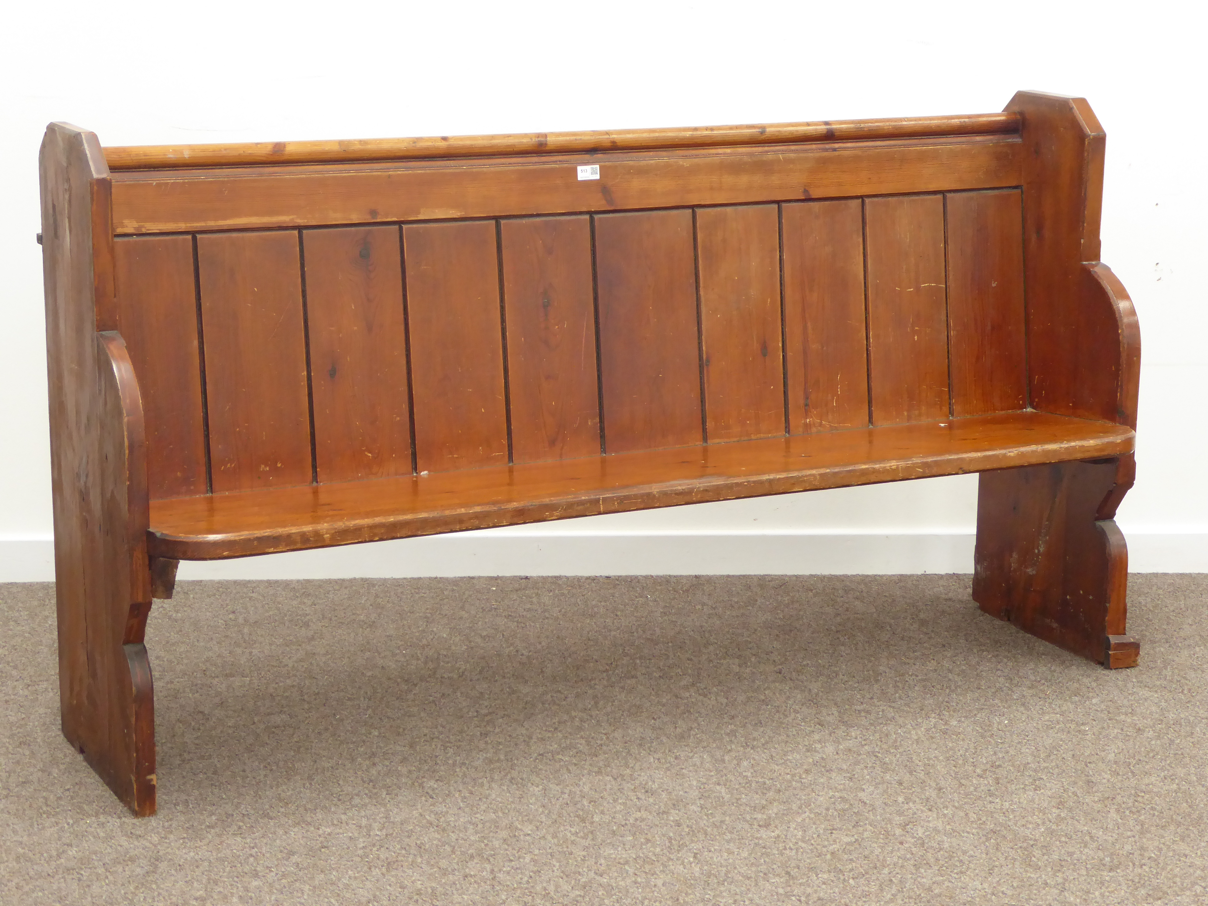 20th century polished pine church pew, panelled back, shaped end supports, W174cm, H94cm,