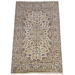 Persian ivory ground rug, decorated with scrolling foliage and central medallion,