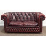 Chesterfield two seat sofa upholstered in deeply buttoned red leather, W156cm,