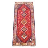 Persian Yallameh red ground runner rug, pole medallions, stylised animals and flowers on red field,