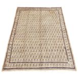 Large Persian Mood beige ground carpet, decorated with repeating Boteh motifs,