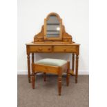 Polished pine kneehole dressing table fitted with drawers and swing mirror,