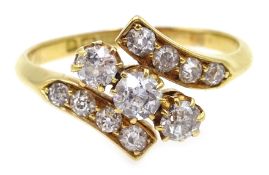 Edwardian 18ct gold three stone diamond crossover ring, with diamond set shoulders,
