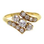 Edwardian 18ct gold three stone diamond crossover ring, with diamond set shoulders,