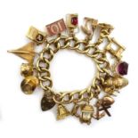 Heavy 9ct gold curb heart locket bracelet, with sixteen 9ct charms, including concord,