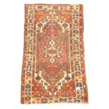 Turkish woollen beige and red ground rug, overall geometric design,