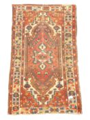 Turkish woollen beige and red ground rug, overall geometric design,