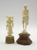 Carved ivory figure of Mahatma Ghandi on a wooden base H18cm and another ivory figure of a lady