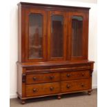 Victorian figured mahogany bookcase on chest, projecting cornice over three glazed doors,