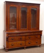 Victorian figured mahogany bookcase on chest, projecting cornice over three glazed doors,