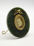 Moss agate oval miniature frame with gilded wreath and tied bow decoration on an easel stand 7.