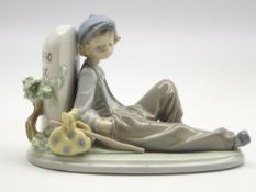 Lladro figure 'Time to Rest' of a boy leaning against a milestone No.