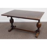 Early 20th century oak extending dining table, twin baluster supports joined by a singe stretcher,