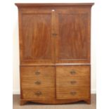 Georgian mahogany double wardrobe disguised as a linen press, projecting faux dentil cornice,