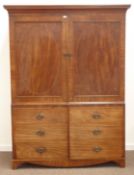 Georgian mahogany double wardrobe disguised as a linen press, projecting faux dentil cornice,