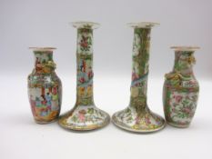 Pair of Cantonese candlesticks decorated with panels of figures and flowers H20cm and a pair of