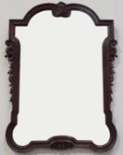 19th century mahogany bevelled wall mirror, with scrolled carved floral decoration,