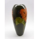 Walter Moorcroft oviform vase decorated with Hibiscus pattern on a green ground,