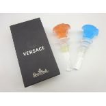 Rosenthal Versace Medusa glass bottle stopper in red and another in blue,