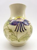 Walter Moorcroft baluster vase decorated with purple Columbine on a cream ground,