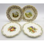 Pair of 19th Century porcelain plates painted with landscape panels within heavily gilded border