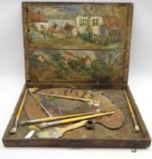 Artists wooden box the interior painted with a landscape and containing a palette,