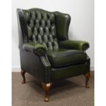 Georgian style wing back arm chair, upholstered in deeply buttoned green leather,