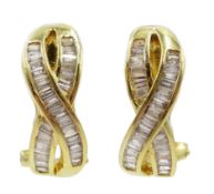 Pair of 18ct gold baguette diamond crossover stud earrings stamped 750, diamonds on each earring 0.