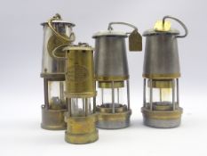 Four miner's brass and white metal lamps comprising Eccles Type GR 6S,