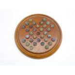 Victorian mahogany solitaire board of circular form with thirty-two hand blown marbles D22cm