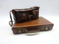 Stitched leather cartridge bag of oblong form with two pouch compartments to the front and carrying