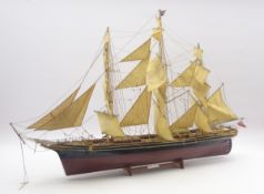 Model of the three masted clipper ship 'Cutty Sark', with black and brown painted wooden hull,