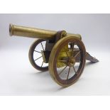 Brass model of a field cannon mounted on an oak carriage with spoked wheels L51cm