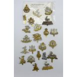 Twenty-three cap badges for various regiments including Warwickshire, Norfolk, Royal Lincolnshire,