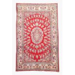 Persian Tabriz design red ground rug, central medallion surrounded by a radial floral pattern,