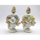 Pair of Sitzendorf vases and covers decorated with applied flowers and cherubs H26cm